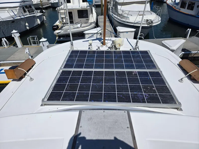 Slide: The Image of 1989 Eagle Pilothouse with solar panels on deck, docked at marina. - 24