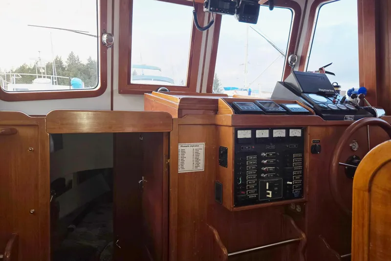 Slide: The Image of 1989 Eagle Pilothouse interior with navigation controls and wooden finish. - 27