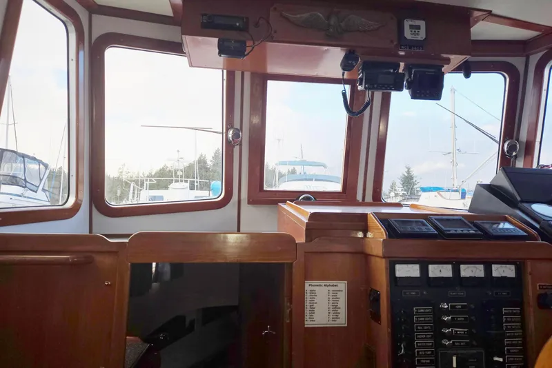 Slide: The Image of 1989 Eagle Pilothouse interior with navigation equipment and marina view. - 29