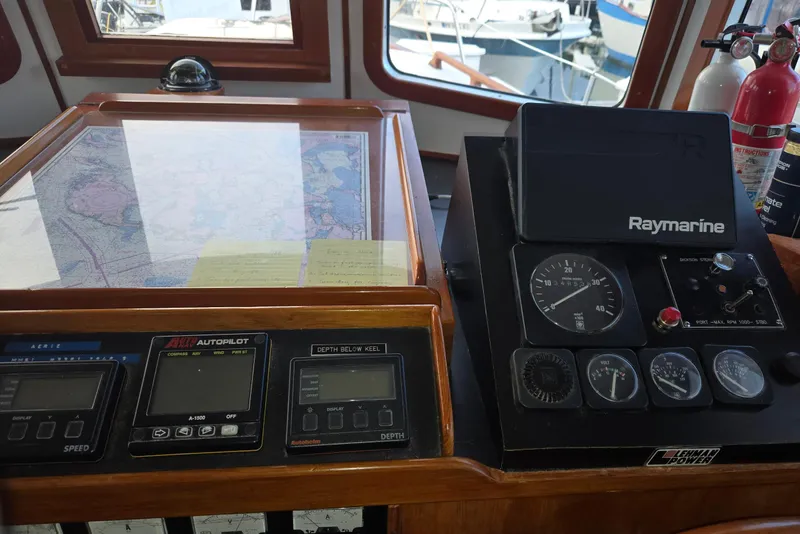 Slide: The Image of 1989 Eagle Pilothouse dashboard with navigation instruments and Raymarine equipment. - 32