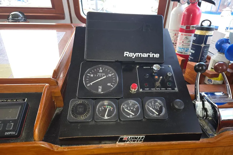 Slide: The Image of 1989 Eagle Pilothouse dashboard with Raymarine equipment and Lehman Power controls. - 33
