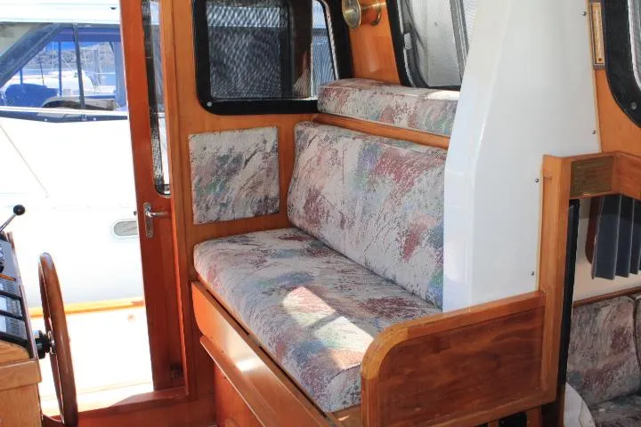 Slide: The Image of 1989 Eagle Pilothouse interior with patterned seating and wooden accents. - 39