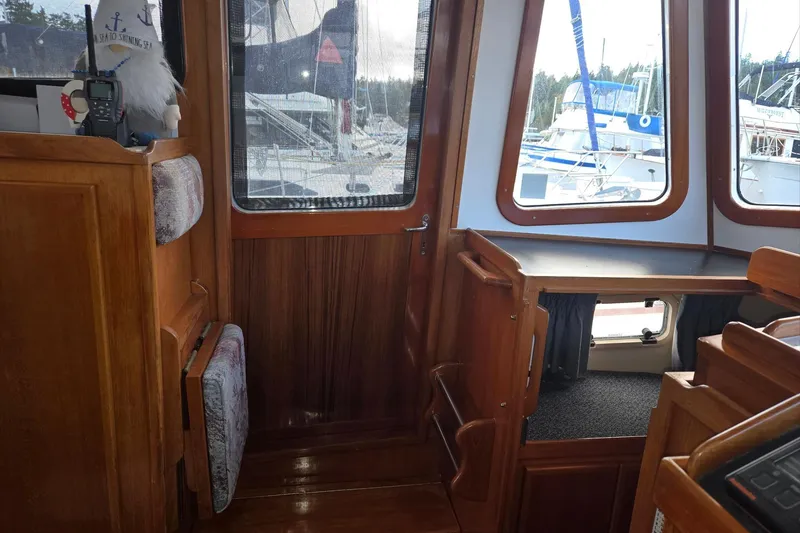 Slide: The Image of 1989 Eagle Pilothouse interior with wooden finish and marina view through windows. - 41