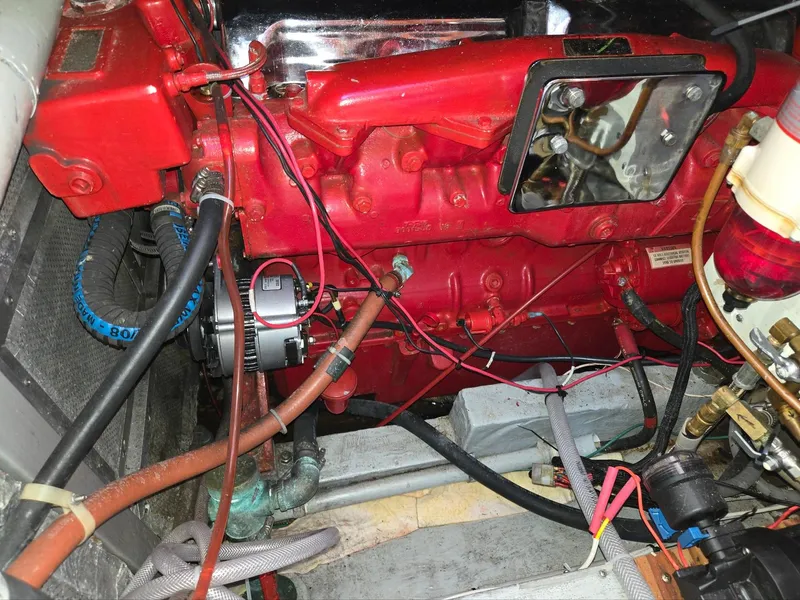 Slide: The Image of Engine compartment of a 1989 Eagle Pilothouse with red components and wiring. - 46
