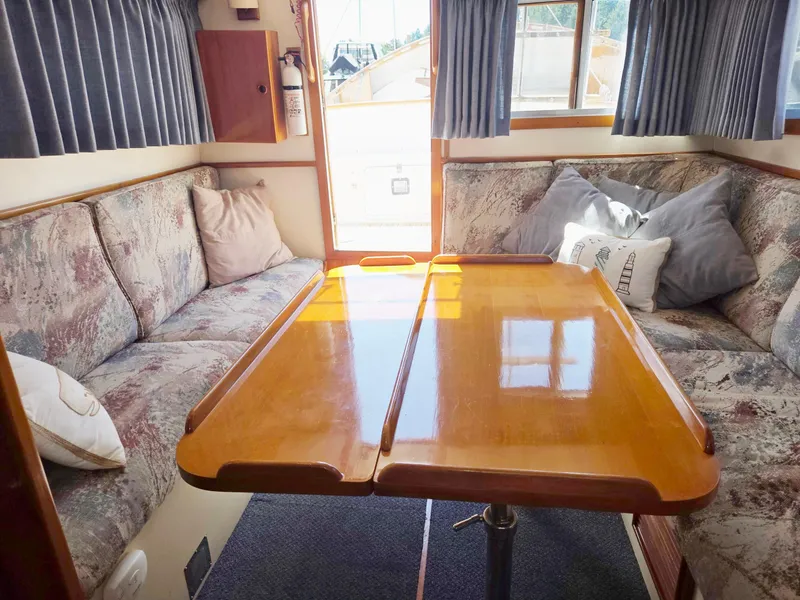 Slide: The Image of 1989 Eagle Pilothouse interior with cozy seating and wooden table. - 55