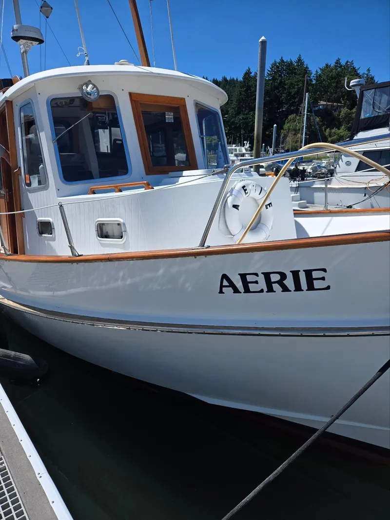 Slide: The Image of 1989 Eagle Pilothouse boat named "Aerie" docked at a marina on a sunny day. - 9