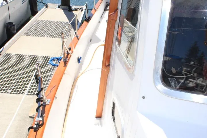 Slide: The Image of 1989 Eagle Pilothouse yacht docked at marina, showcasing deck and cabin details. - 11