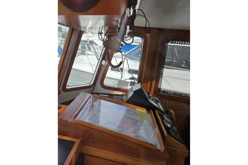 Slide: The Image of 1989 Eagle Pilothouse interior with navigation equipment and windows. - 31