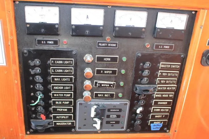 Slide: The Image of 1989 Eagle Pilothouse control panel with switches, gauges, and labels for various boat functions. - 43