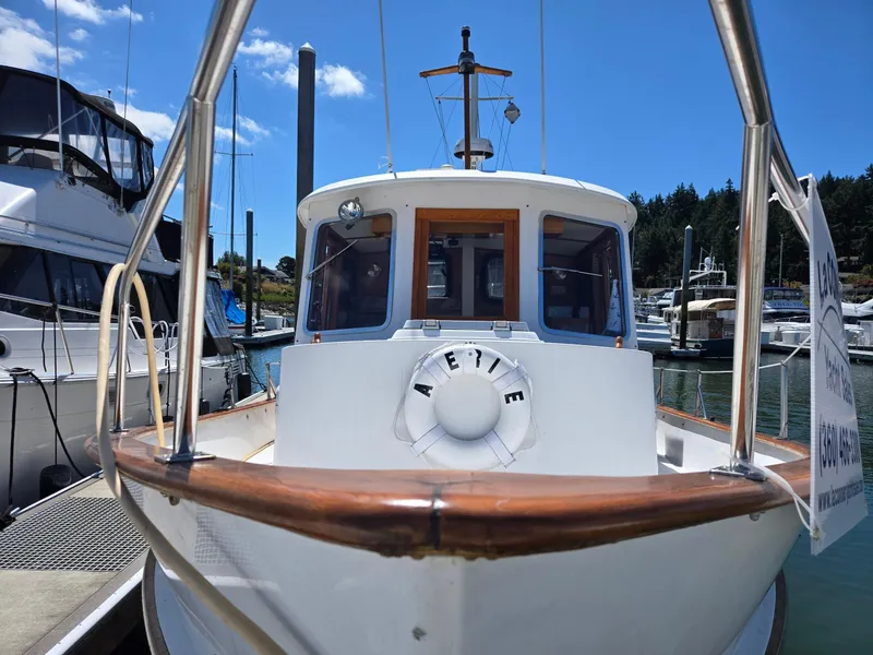 Slide: The Image of 1989 Eagle Pilothouse boat docked at marina under clear blue sky. - 5