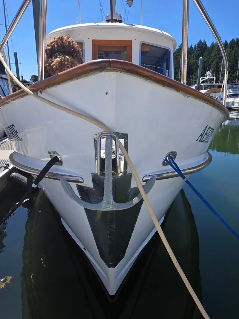 Slide: The Image of Front view of a 1989 Eagle Pilothouse boat docked in a marina. - 7