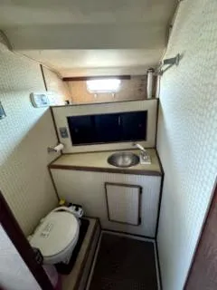 Slide: The Image of 1979 Morgan Out Island yacht bathroom with sink, toilet, and storage. - 10