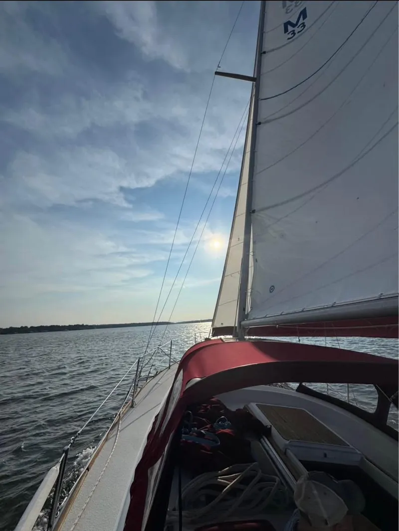 Slide: The Image of 1979 Morgan Out Island sailboat on open water under a clear sky. - 3
