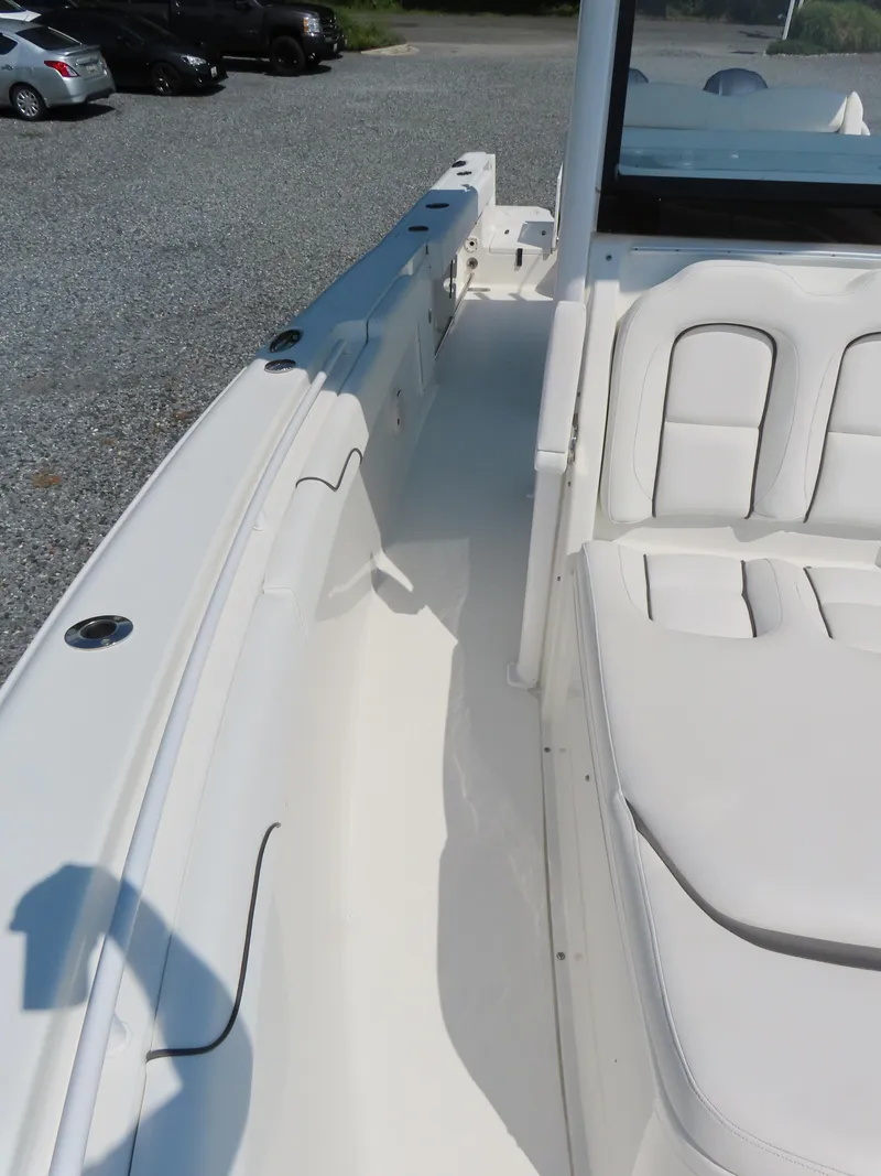 Slide: The Image of 2017 Sea Hunt Gamefish 27 boat interior with white seating and spacious deck. - 14