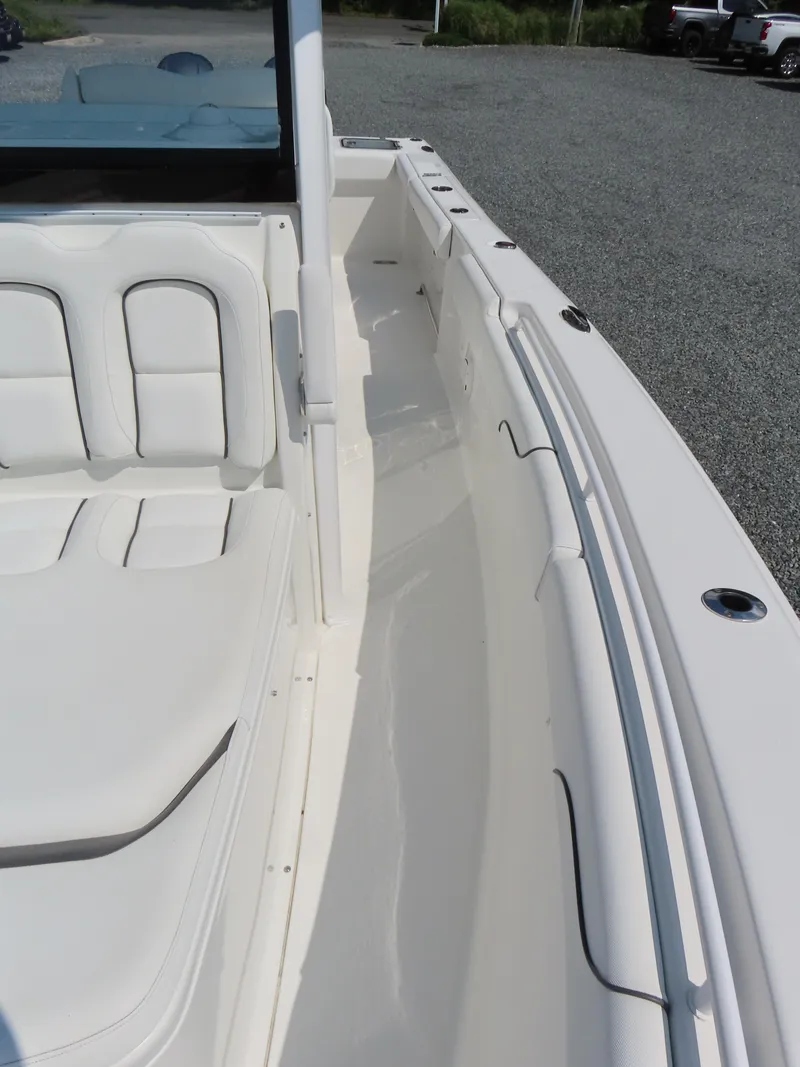 Slide: The Image of 2017 Sea Hunt Gamefish 27 boat interior with white seating and clean deck. - 15