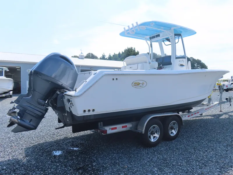 Slide: The Image of 2017 Sea Hunt Gamefish 27 boat on trailer, featuring dual outboard engines. - 2