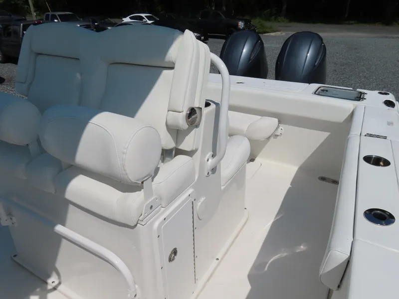 Slide: The Image of 2017 Sea Hunt Gamefish 27 boat interior with white seating and dual engines. - 21