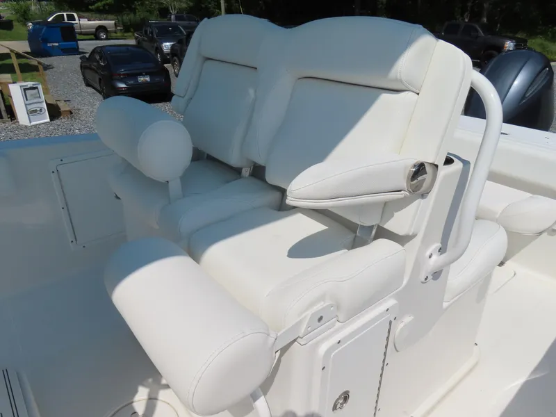 Slide: The Image of 2017 Sea Hunt Gamefish 27 boat with white cushioned seating and armrests. - 23