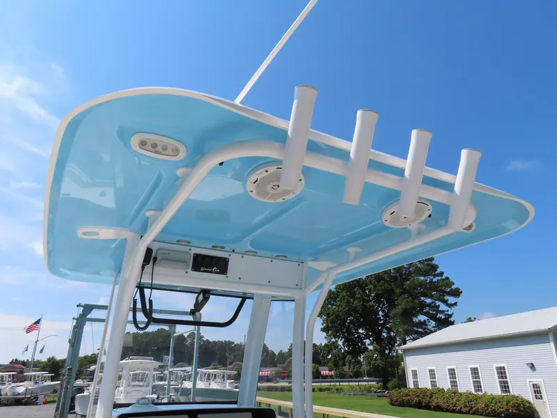 Slide: The Image of 2017 Sea Hunt Gamefish 27 boat with blue T-top and rod holders under clear sky. - 28