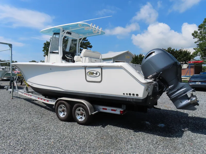 Slide: The Image of 2017 Sea Hunt Gamefish 27 boat on trailer, parked outdoors under blue sky. - 3
