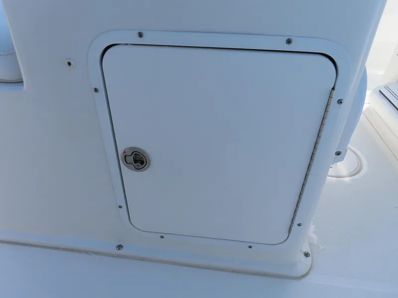 Slide: The Image of 2017 Sea Hunt Gamefish 27 boat storage compartment with secure latch. - 31