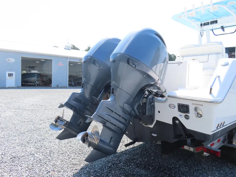 Slide: The Image of 2017 Sea Hunt Gamefish 27 with dual outboard motors in a boatyard setting. - 4