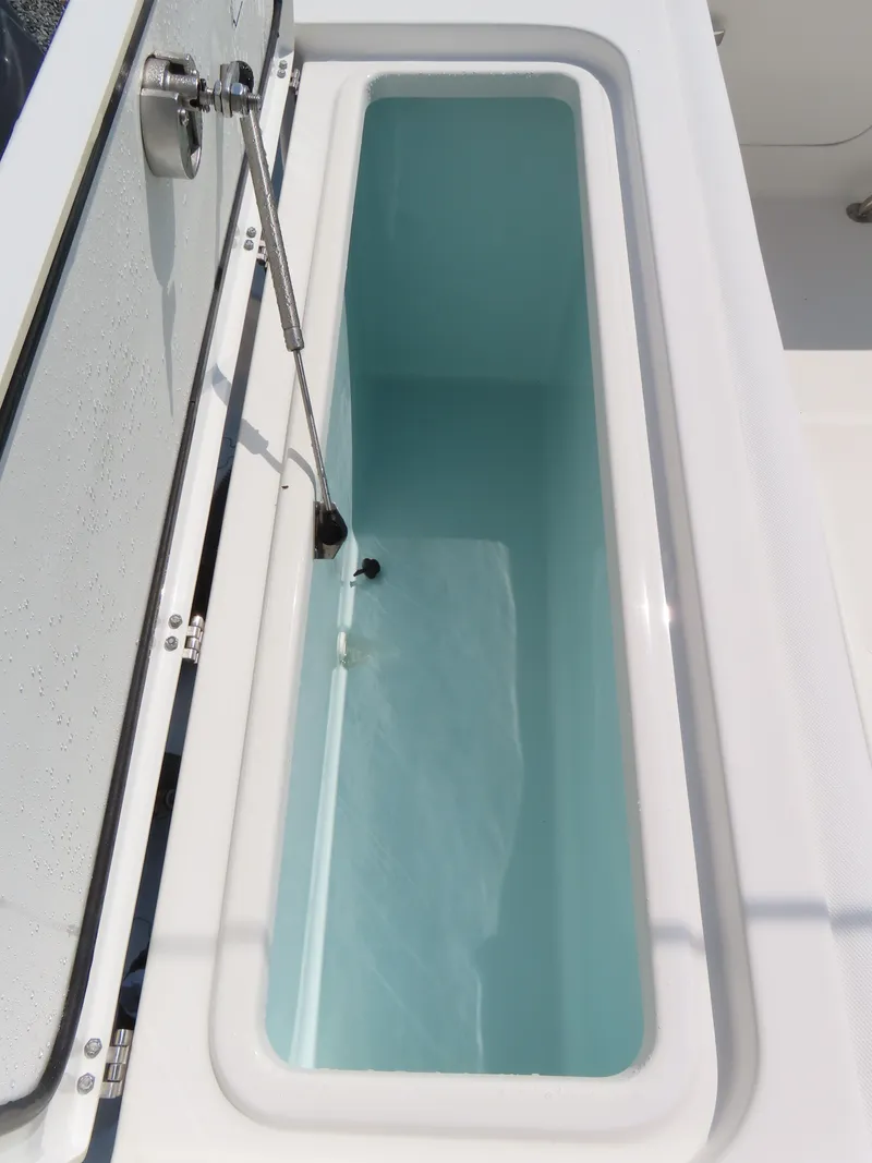 Slide: The Image of Livewell on 2017 Sea Hunt Gamefish 27 boat, open lid, filled with water. - 45