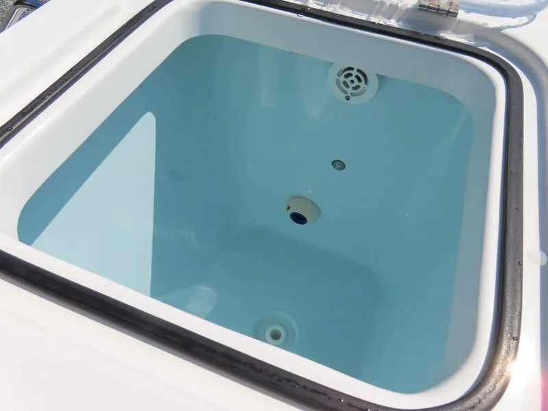 Slide: The Image of Livewell compartment on a 2017 Sea Hunt Gamefish 27 boat, featuring a clean interior. - 47