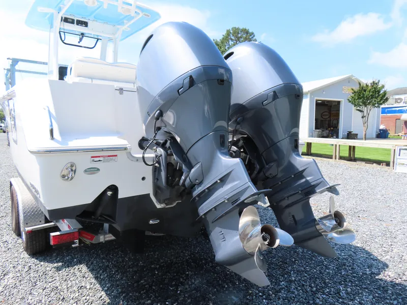 Slide: The Image of 2017 Sea Hunt Gamefish 27 boat with dual outboard motors on a trailer. - 5