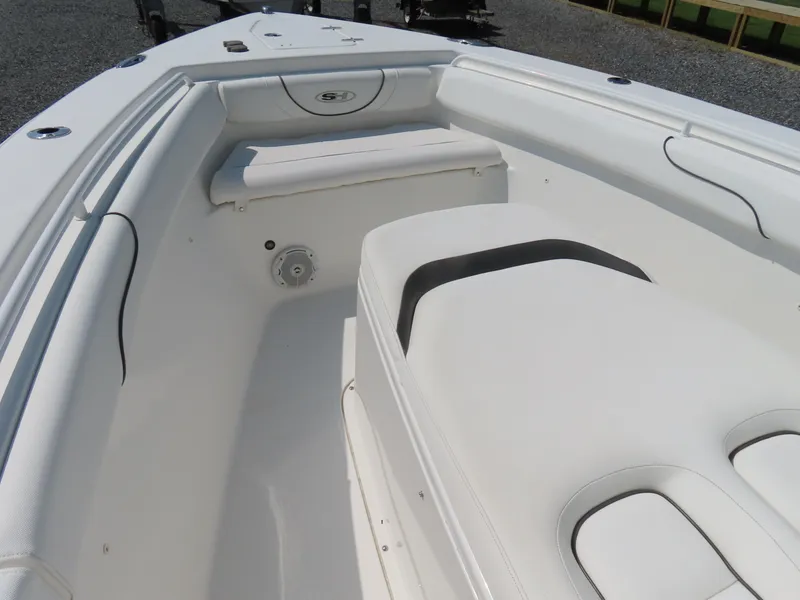 Slide: The Image of 2017 Sea Hunt Gamefish 27 boat interior with white seating and storage compartments. - 7