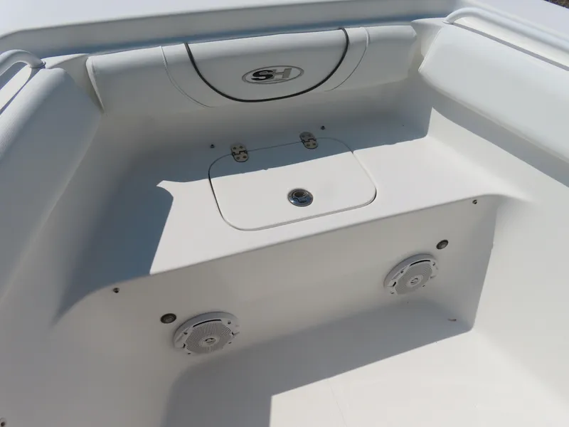 Slide: The Image of 2017 Sea Hunt Gamefish 27 boat interior with storage compartment and speakers. - 9
