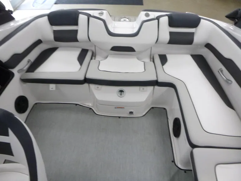 Slide: The Image of 2025 Yamaha Boats AR195 interior seating with sleek white and black upholstery. - 11
