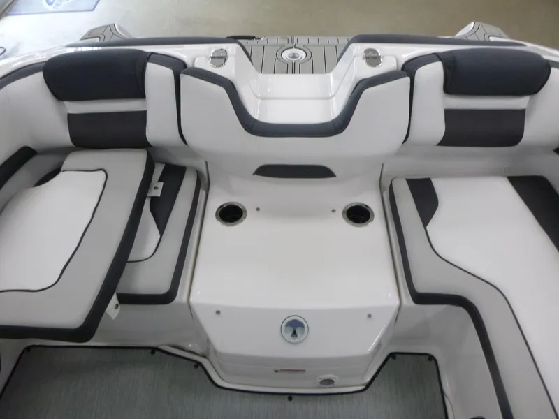 Slide: The Image of 2025 Yamaha Boats AR195 interior seating with sleek design and cup holders. - 12