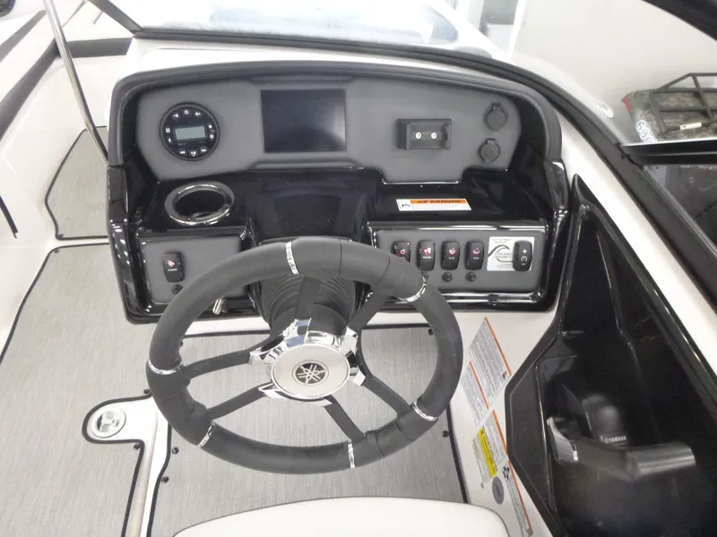 Slide: The Image of 2025 Yamaha AR195 boat dashboard with steering wheel and control panel. - 8