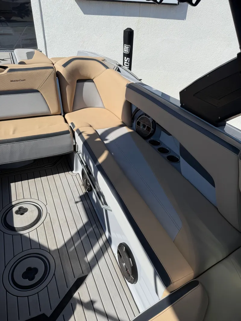 Slide: The Image of 2022 MasterCraft XStarS boat interior with beige seating and modern design. - 14