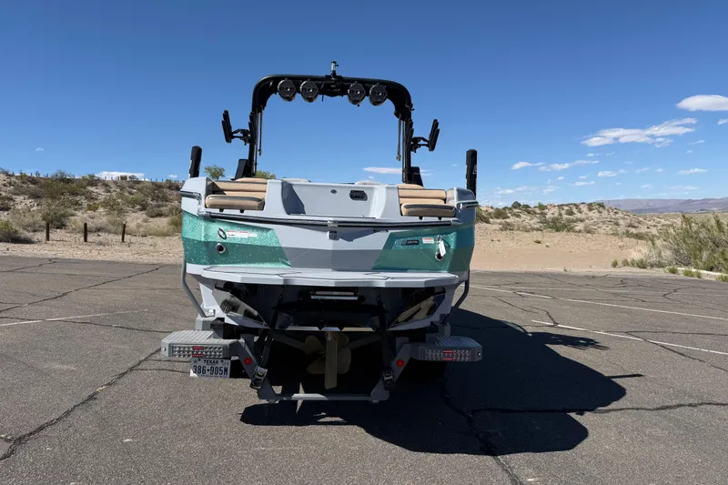 Slide: The Image of 2022 MasterCraft XStar boat parked on a sunny desert road. - 16