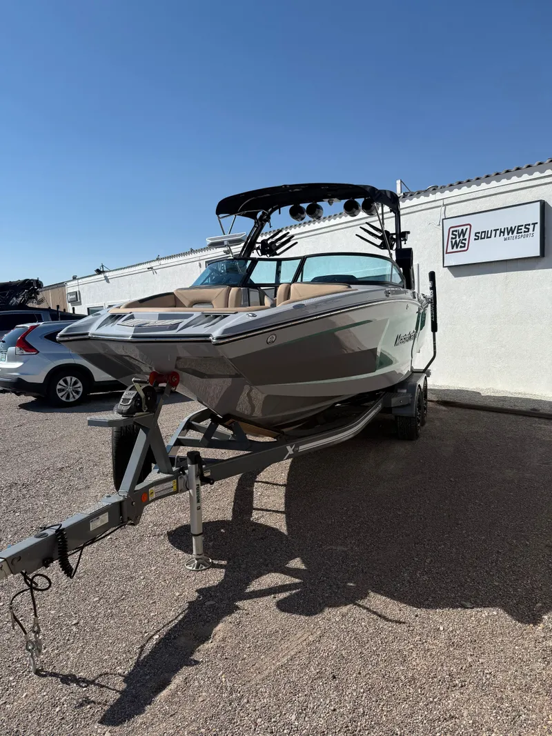 Slide: The Image of 2022 MasterCraft XStarS boat on trailer at Southwest Watersports dealership. - 2