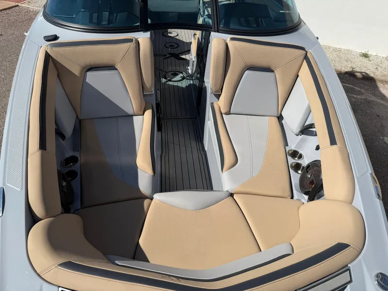 Slide: The Image of 2022 MasterCraft XStarS boat interior with beige and gray seating, overhead view. - 4