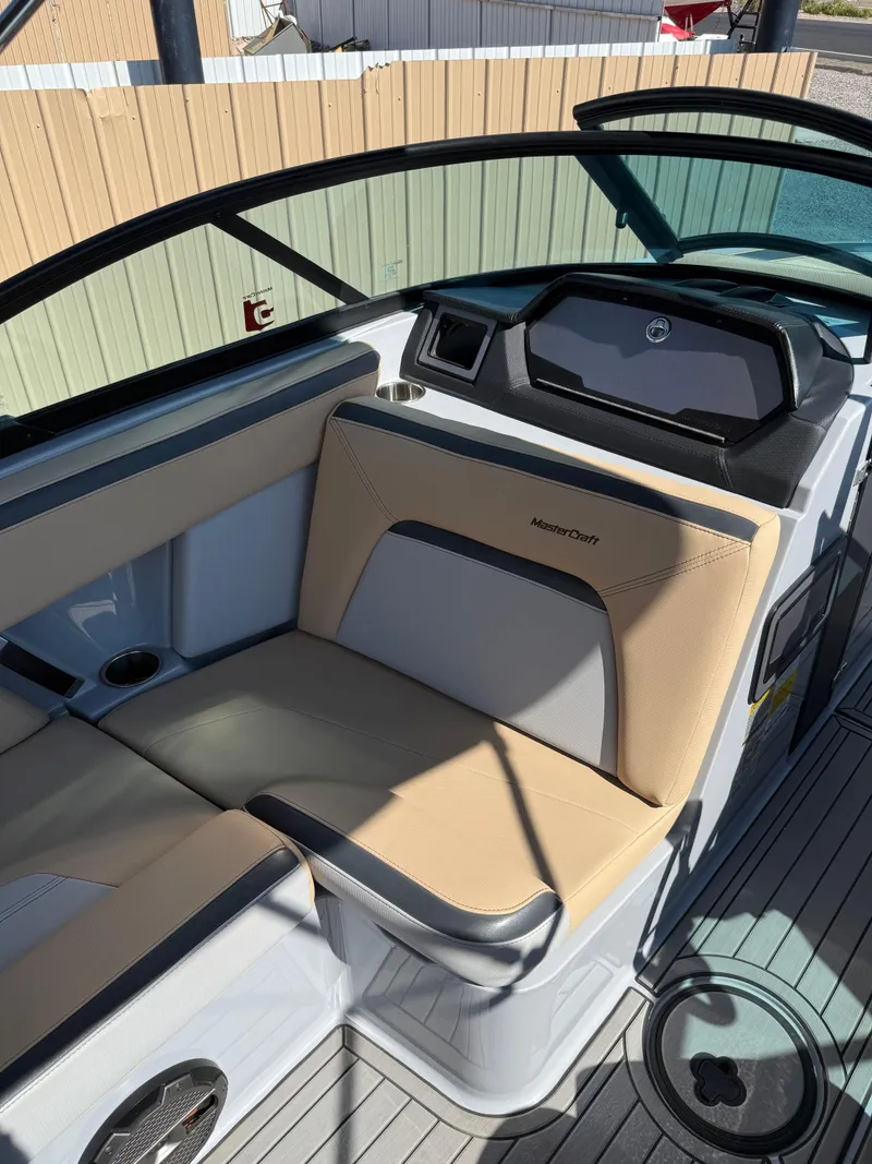 Slide: The Image of 2022 MasterCraft XStarS boat interior with beige seating and modern dashboard. - 5