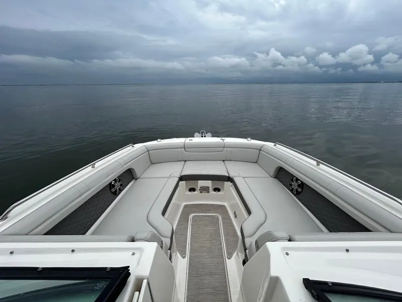 Slide: The Image of 2020 Sea Ray SDX 290 Outboard boat interior with spacious seating, overlooking calm waters. - 10