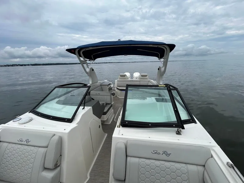 Slide: The Image of 2020 Sea Ray SDX 290 Outboard boat on calm water under cloudy skies. - 12