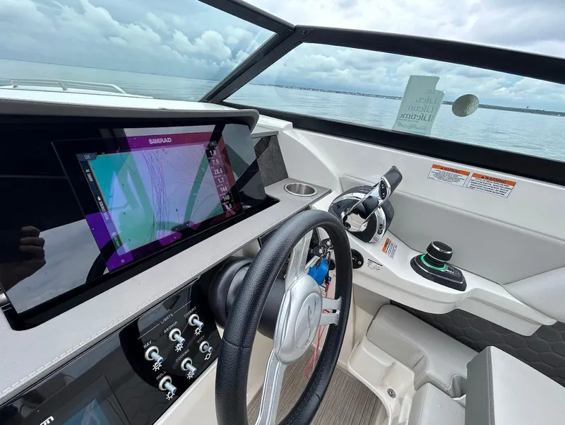 Slide: The Image of 2020 Sea Ray SDX 290 Outboard dashboard with navigation display and controls. - 16