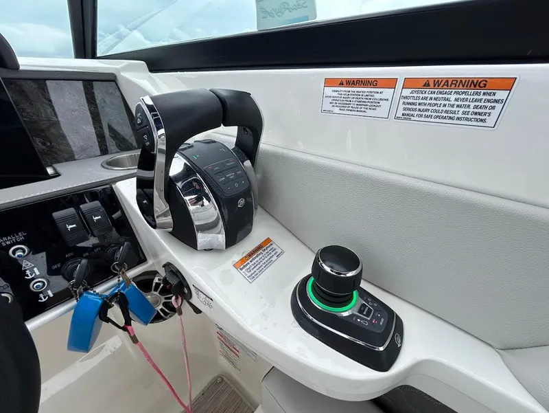 Slide: The Image of Control panel of 2020 Sea Ray SDX 290 Outboard with joystick and throttle controls. - 17