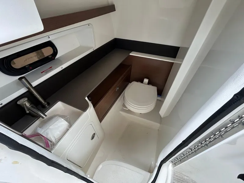 Slide: The Image of 2020 Sea Ray SDX 290 Outboard boat interior with compact bathroom and modern fixtures. - 19