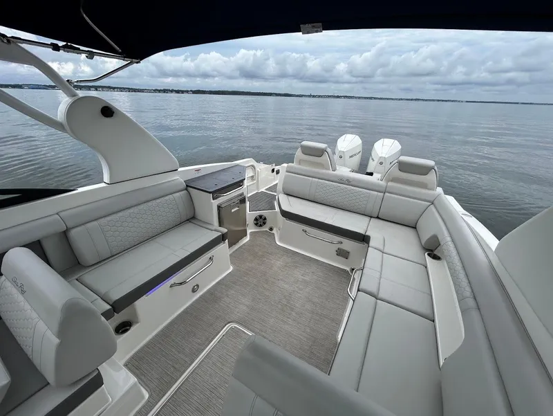 Slide: The Image of 2020 Sea Ray SDX 290 Outboard boat interior with spacious seating and scenic water view. - 20