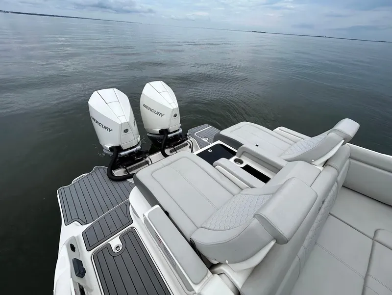 Slide: The Image of 2020 Sea Ray SDX 290 Outboard with dual Mercury engines on calm water. - 25