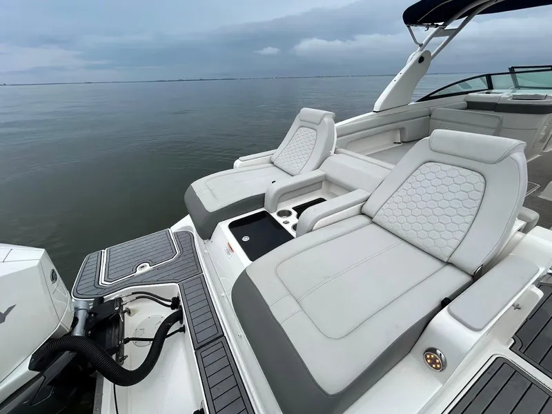 Slide: The Image of 2020 Sea Ray SDX 290 Outboard with luxurious seating on calm waters. - 26