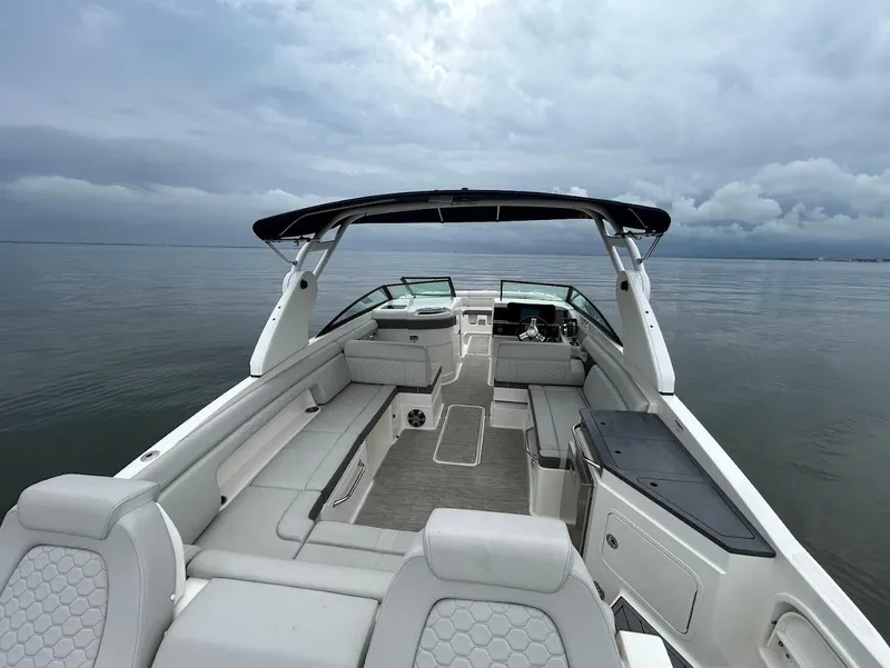 Slide: The Image of 2020 Sea Ray SDX 290 Outboard boat interior with spacious seating on calm water. - 28