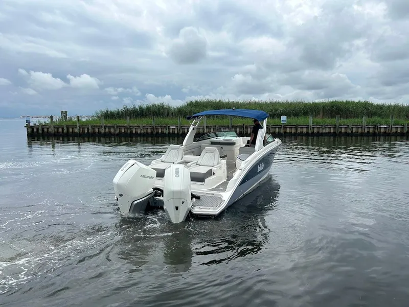 Slide: The Image of 2020 Sea Ray SDX 290 Outboard boat on calm water near a dock. - 8