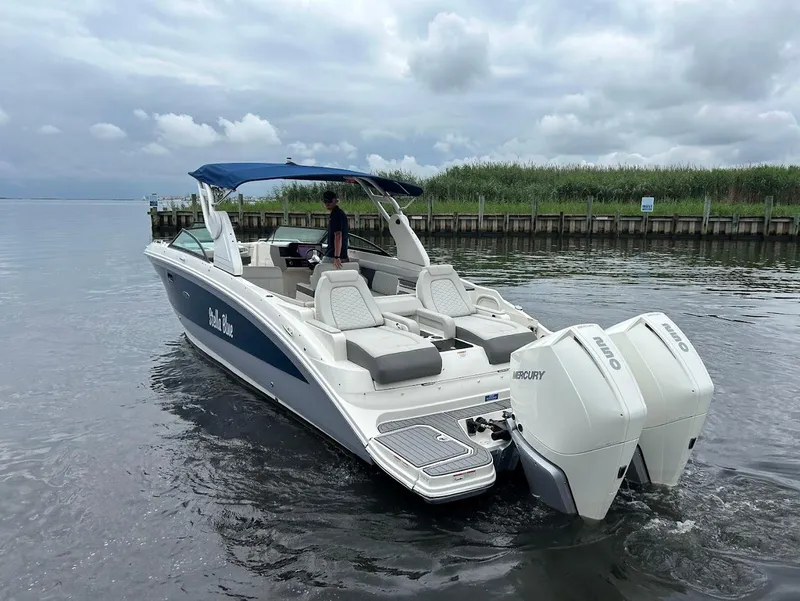 Slide: The Image of 2020 Sea Ray SDX 290 Outboard boat on water, featuring dual Mercury engines. - 9